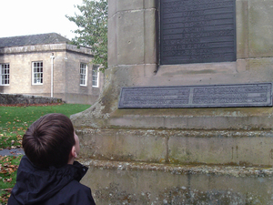 Pupil from Melrose Primary School looking at Melrose war memorial, Scottish Borders ©War Memorial Trust, 2017